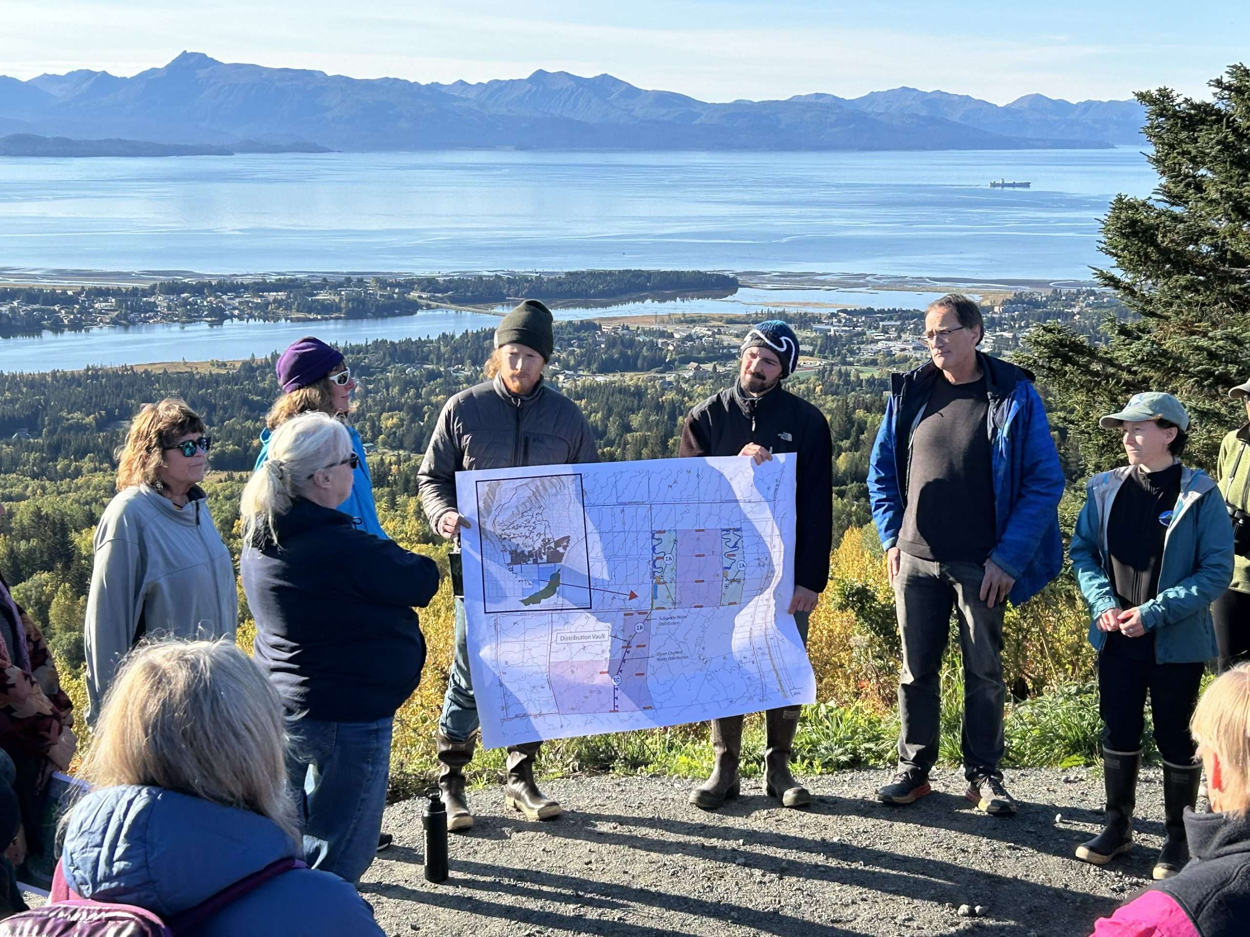 People showing map of stormwater project at scenic overlook.
