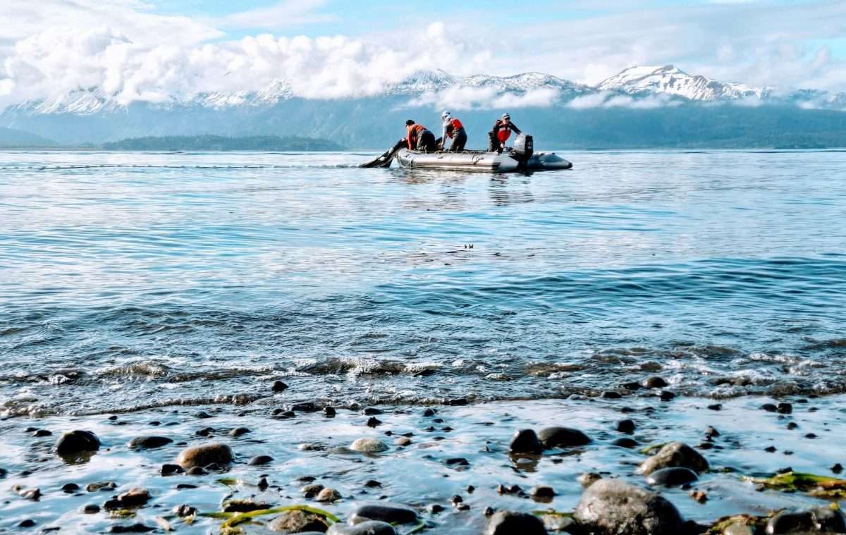People in a zodiak with a net in Kachemak Bay