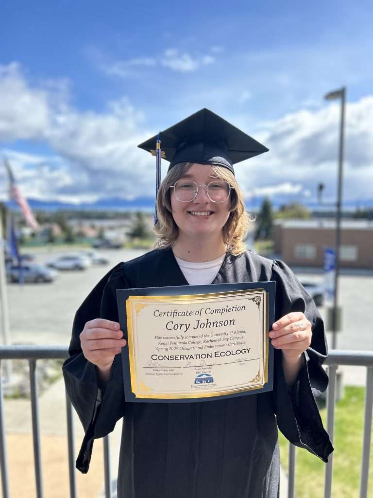 student holding certificate of completion