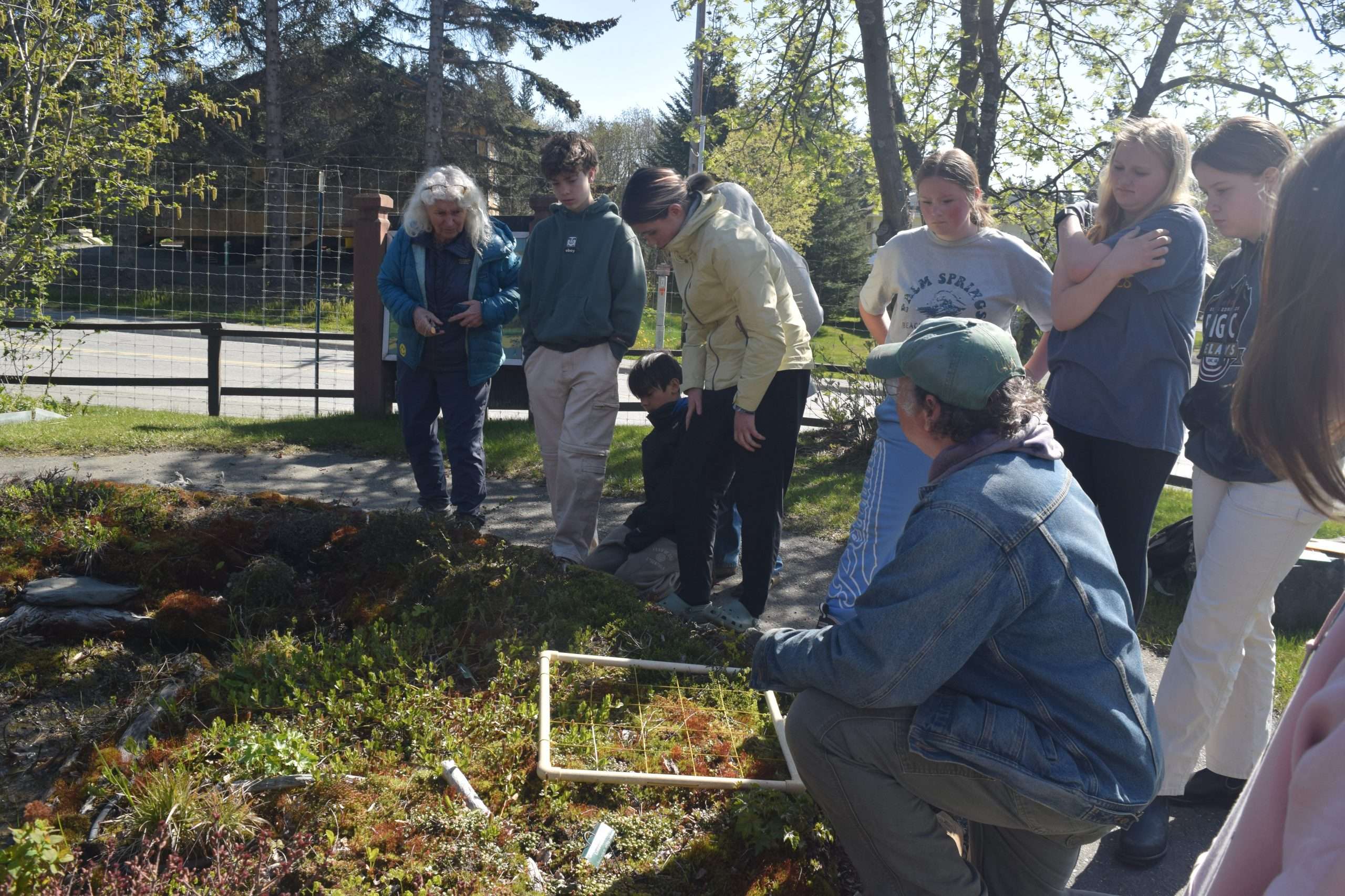 students outside planting orchids at Pratt Museum