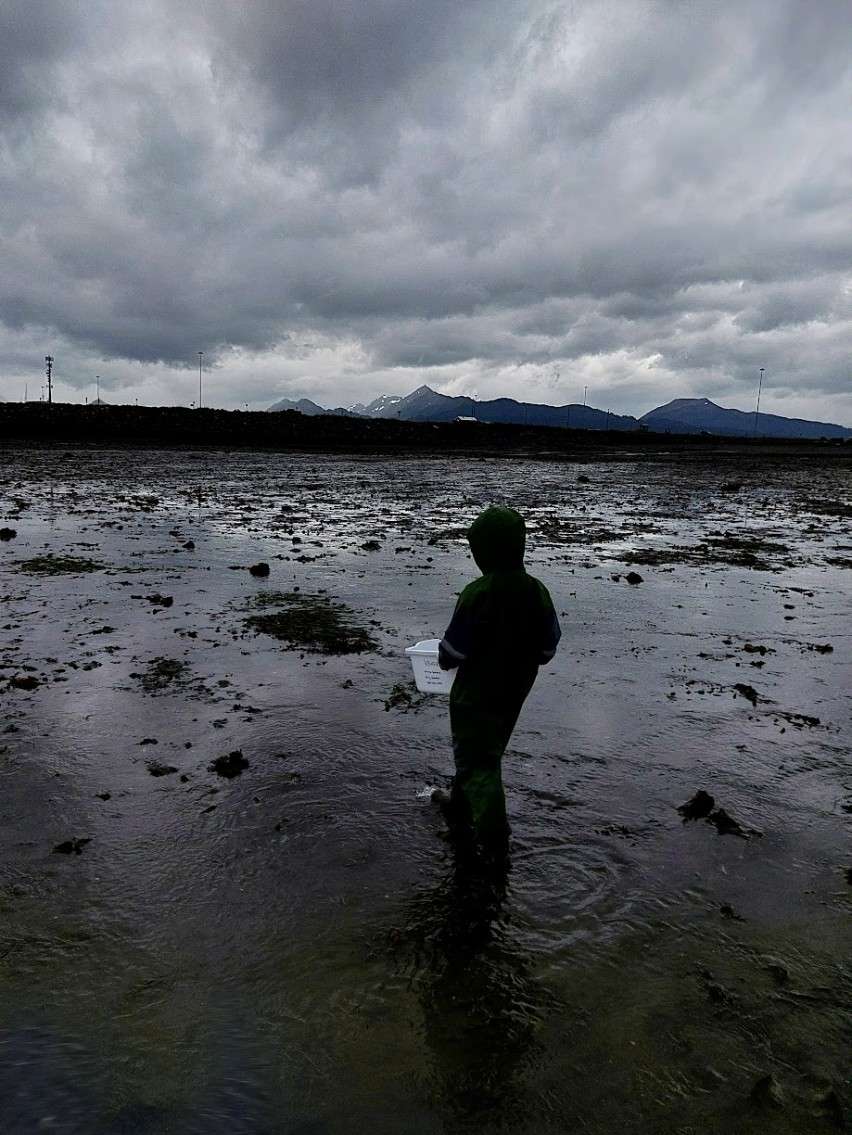student on beach with crab trap
