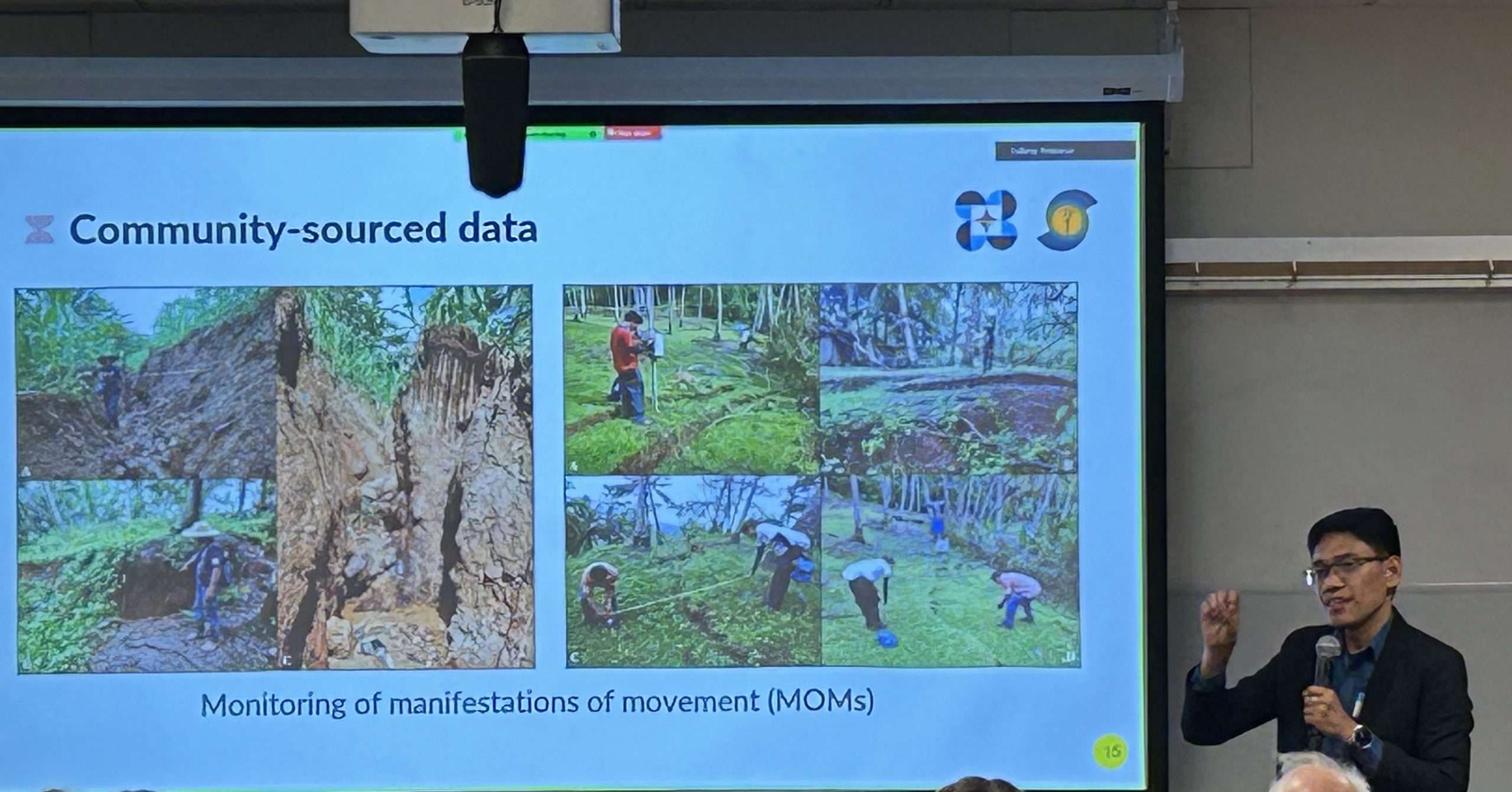 Presenter with slides showing photos of landslide monitoring in Phillippines.