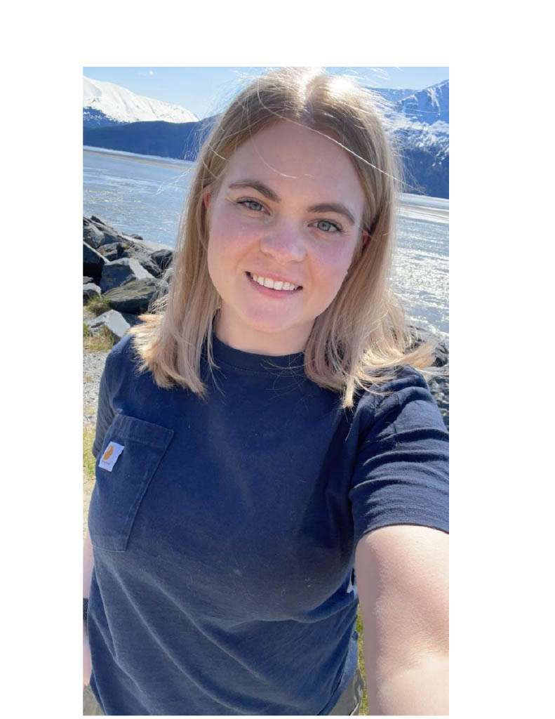 Face image of intern with mountains and water in background.