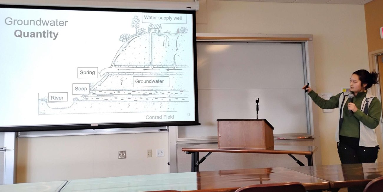 Presenter shows a slide on cross-section of groundwater flow
