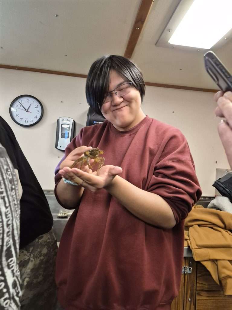 student holds a native crab