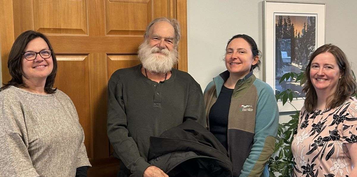 4 people standing in a room