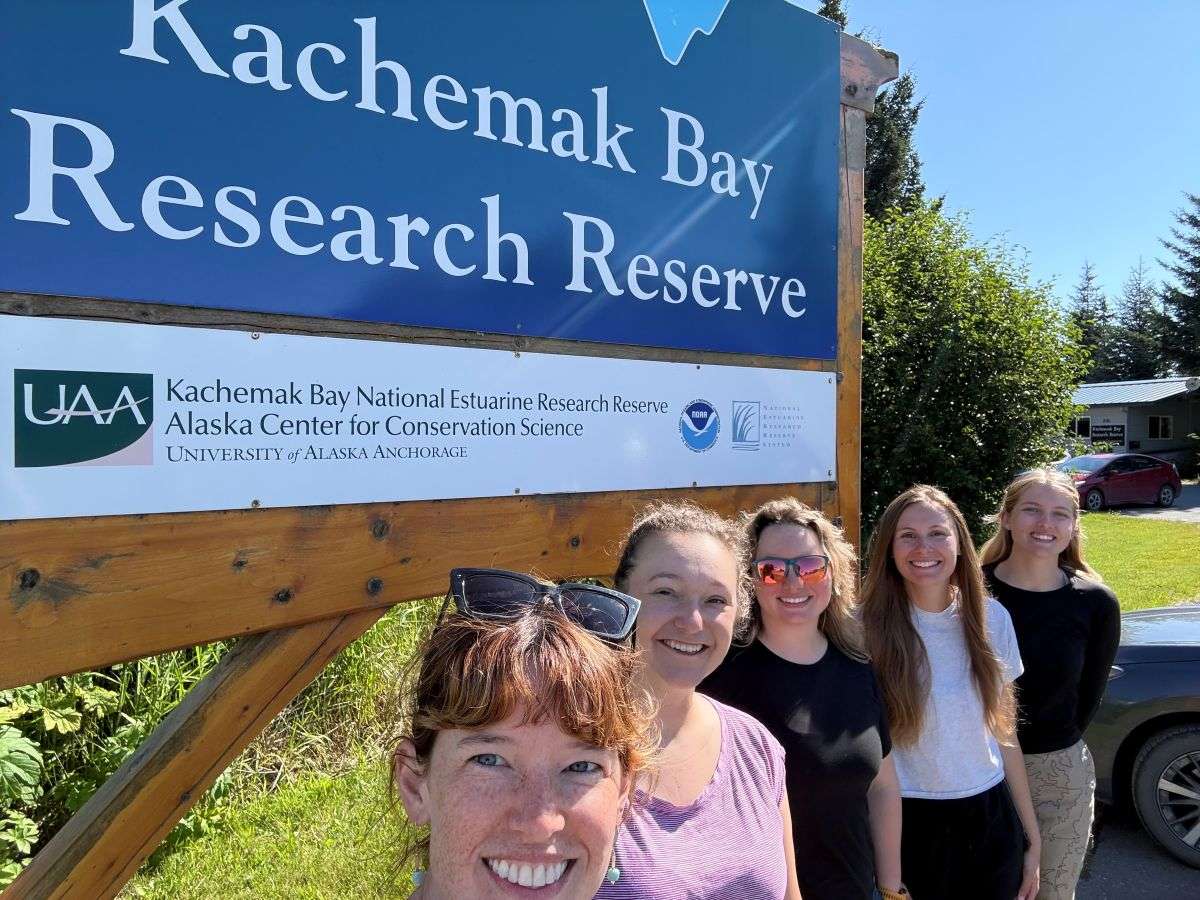 people in front of KBNERR sign